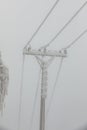 Frozen power line pylons. Hoarfrost on high voltage cables and pylons. Winter in the mountains Royalty Free Stock Photo