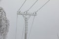 Frozen power line pylons. Hoarfrost on high voltage cables and pylons. Winter in the mountains Royalty Free Stock Photo