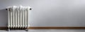 Frozen Radiator Against a Plain Wall. An old-style white radiator with ice formations indoors. Background with copy Royalty Free Stock Photo