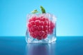 Frozen raspberry in an ice club on a neon background