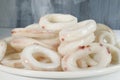 Frozen raw squid rings on white plate Royalty Free Stock Photo