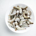 Frozen raw uncooked tiger prawns, shrimps, on white stone  surface, top view flat lay, square format Royalty Free Stock Photo