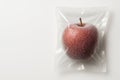 Frozen red apple in vacuum packaging. Space for text. Royalty Free Stock Photo
