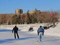 People scating and relaxing on a bench on frozen rideau canal in Ottawa