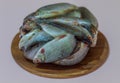 Frozen river fish lies on a wooden round board for slicing food Royalty Free Stock Photo
