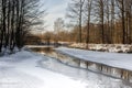 frozen river in a park with trees along the banks