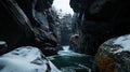 A frozen river winds through a deep gorge, surrounded by towering cliffs and snow-covered trees. Royalty Free Stock Photo