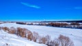 Frozen river winter covered with snow. Beautiful lake landscape in ice. Clear blue sky with clouds. Royalty Free Stock Photo