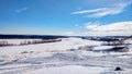 Frozen river in winter covered with snow. Beautiful lake landscape in ice. Clear blue sky with clouds. Royalty Free Stock Photo
