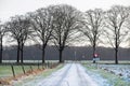 Frozen road in rural dutch winter landscape.