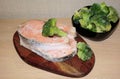 Frozen salmon fillet two pieces on a board with broccoli Royalty Free Stock Photo