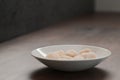 frozen scallops in white bowl on walnut table for defrosting Royalty Free Stock Photo