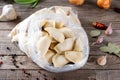 Frozen semi-finished products on a table with ingredients. Russian dumplings. Meat dumplings, ravioli. Dumplings with stuffing