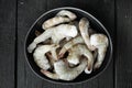 Frozen shell on Tiger Prawns or Asian tiger Shrimps, on black wooden background, top view flat lay