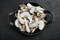 Frozen shell on Tiger Prawns or Asian tiger Shrimps, in cast iron frying pan, on black stone background, top view flat lay Royalty Free Stock Photo