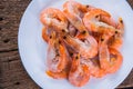 Frozen shrimp with ice cubes on a wood background Royalty Free Stock Photo