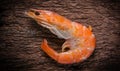 Frozen shrimp with ice cubes on a wood background Royalty Free Stock Photo