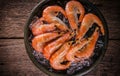 Frozen shrimp with ice cubes on a wood background Royalty Free Stock Photo