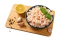 Frozen shrimps in a bowl over cutting board cutout. Boiled peeled prawn tails, lemon, garlic and pepper isolated on a white Royalty Free Stock Photo