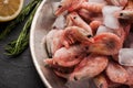 Frozen shrimps in the metal plate with lemon and rosemary