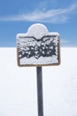 Frozen sign covered in snow