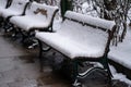 Frozen snow covered chair in winter park Royalty Free Stock Photo