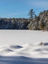 Snow drifts on frozen Turtle Lake Royalty Free Stock Photo