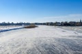 Frozen and snowy Dutch landscape with clear blue sky. frozen water in canal