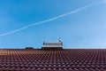 Frozen solar water heater boiler on rooftop, passing aeroplane Royalty Free Stock Photo