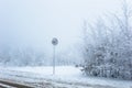 Frozen speed limit sign on a snowy winter background