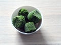 Frozen spinach cubes in a white bowl