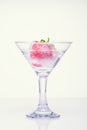 Frozen splashes of clean, spring water, in glass with frozen strawberries, white background Royalty Free Stock Photo