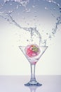 Frozen splashes of clean, spring water, in glass with frozen strawberries, on a white background Royalty Free Stock Photo