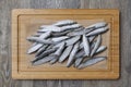 Frozen sprats on a kitchen board close-up, Royalty Free Stock Photo