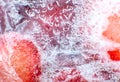 Frozen strawberries texture. Close up. Cold fruit in snow