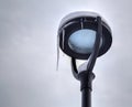 Frozen street light with icicles in cold winter day Royalty Free Stock Photo