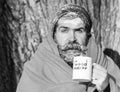 Frozen surprised man, bearded hipster, with beard and moustache covered with white frost and orange blanket with warming Royalty Free Stock Photo