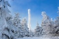 Frozen television or cellular tower in heavy snow near ski center. Telecommunication towers with dish and mobile antenna against Royalty Free Stock Photo