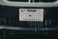 Frozen Texas license number with icicles. Icy frosty cover Black SUV car bumper and plate number in severe winter storm Royalty Free Stock Photo