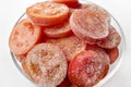 Frozen tomato rings in a glass plate close-up. Frozen tomatoes. Soft focus. Concept of healthy eating