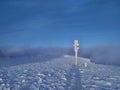 Frozen tourist crossroads on the summit of Snezka, Krkonose Mountains.