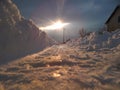 Frozen Track of a car in the snow. The sun breaks through the clouds