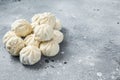 Frozen uncooked baozi dumplings stuffed with meat. Gray background. Top view. Copy space