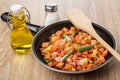 Frozen vegetable mix in frying pan, salt, oil and spatula Royalty Free Stock Photo