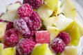 Frozen vegetables in a bowl. winter vitamins - frozen fruits. in a glass bowl are frozen pieces of apples and raspberries