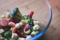 Frozen vegetables broccoli, baby carrot, baby corn, red pepper and peas in a glass bowl Royalty Free Stock Photo