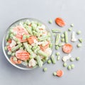 Frozen vegetables in glass bowl and on a table, top view, square format Royalty Free Stock Photo
