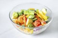 Frozen vegetables in a glass plate on a white background. The concept of healthy eating Royalty Free Stock Photo