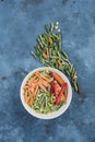 Frozen vegetables: a Mexican mix of vegetables in a deep white plate with string beans on a blue background Royalty Free Stock Photo