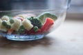 Frozen vegetables mixture with broccoli, red pepper, baby carrot, baby corn and peas in a glass bowl Royalty Free Stock Photo